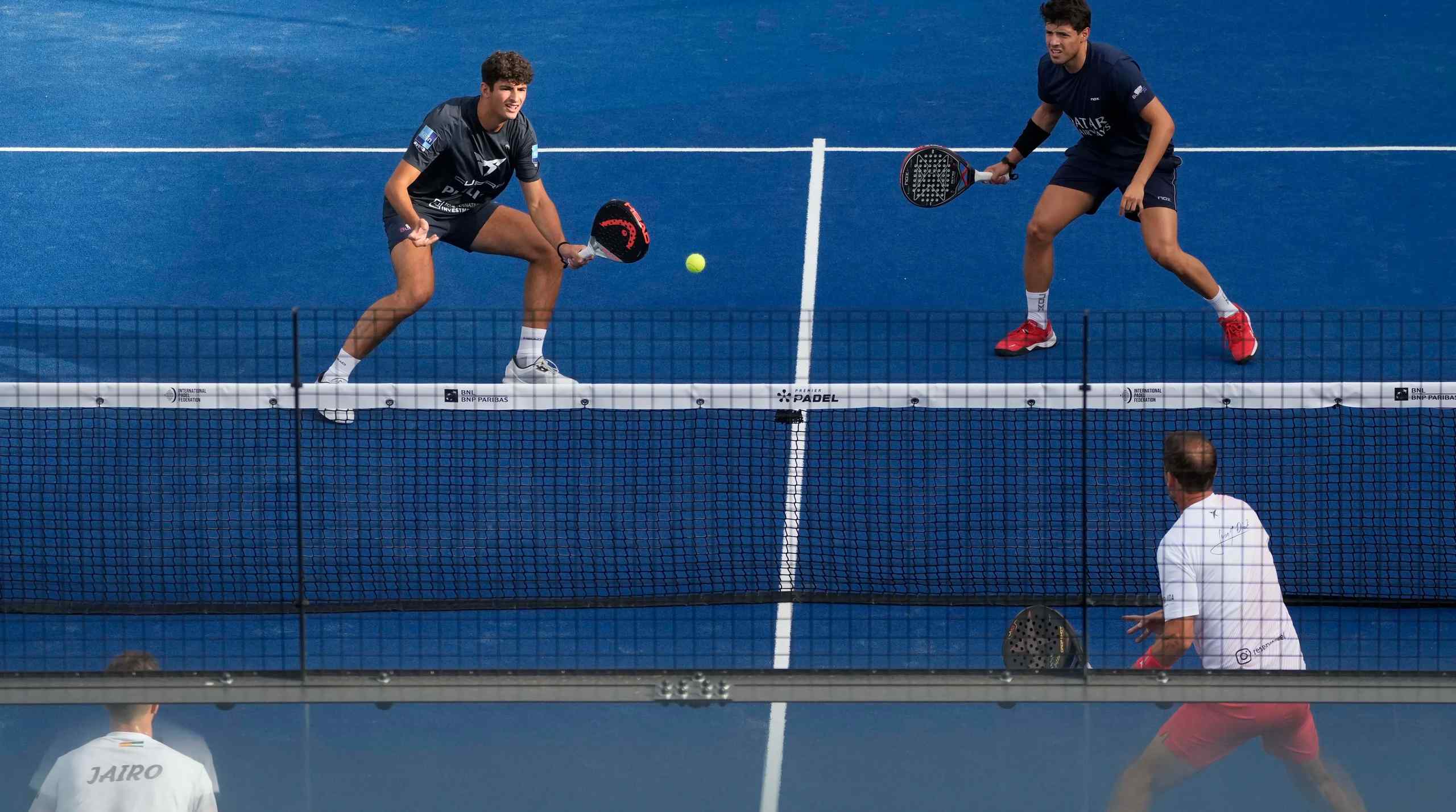 Two men playing padel